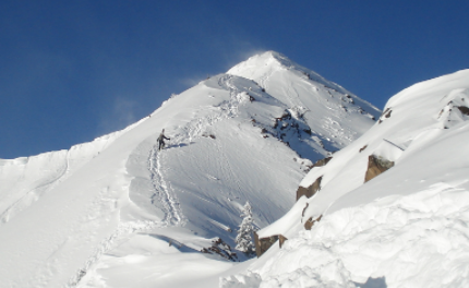 Snow capped mountain with climber